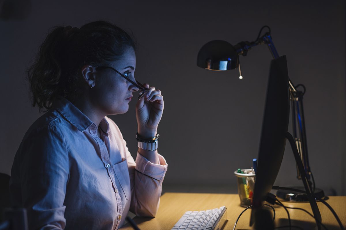 Designer reviewing brand design work at her desk – content creation and graphic design by EP Digital