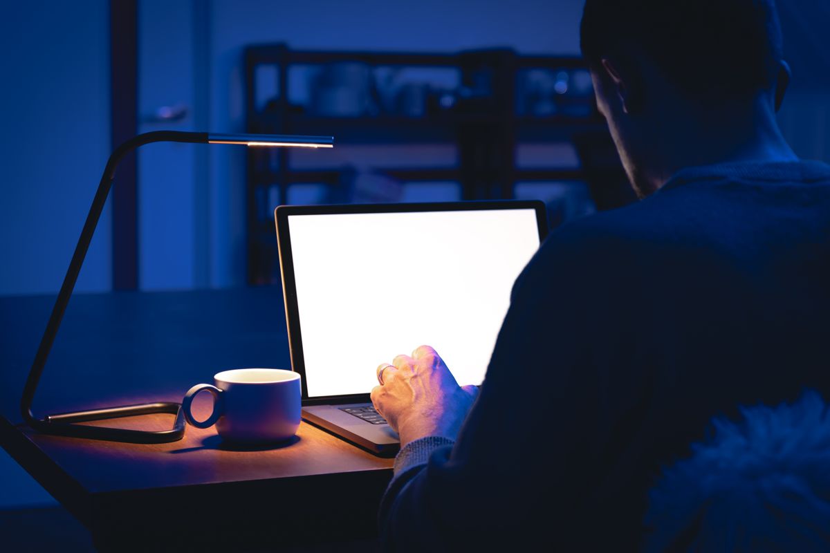 Laptop glowing in a dark room – website design and development by EP Digital